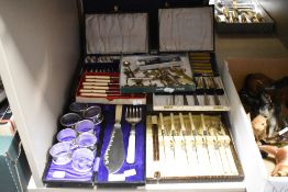 An assortment of vintage cutlery, many sets in boxes, including fish servers and knives and forks,