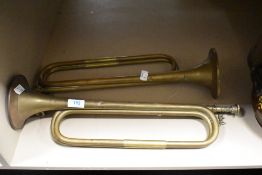 Two vintage brass bugles.