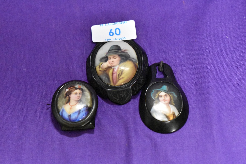 Three 19th Century painted pendant miniatures, mounted in Whitby jet