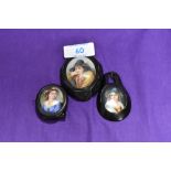 Three 19th Century painted pendant miniatures, mounted in Whitby jet