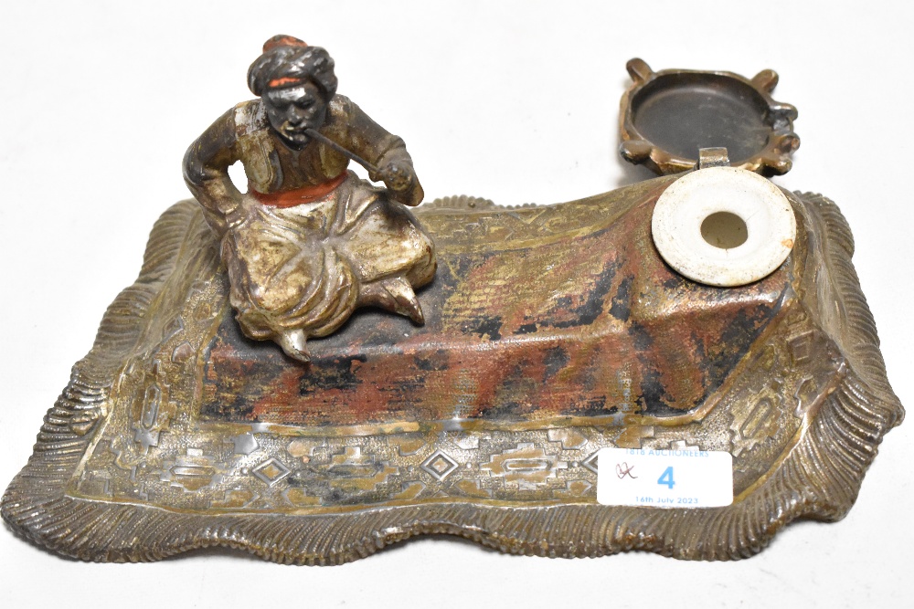 After bergmann, a cold painted cast metal ink well depicting smoking man on flying carpet - Image 2 of 2