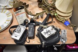 A selection of cameras and accessories, including Canon digital IXUS, a vintage GINO compact III