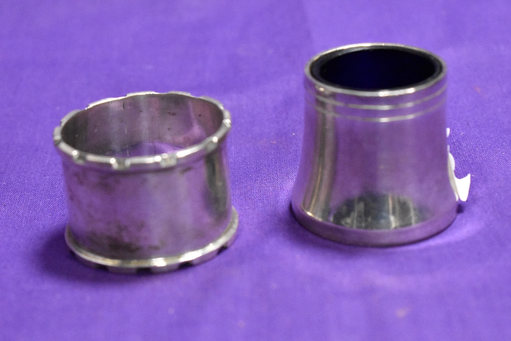 A John Rose of Birmingham silver napkin ring with engraved initials and a white metal salt with blue