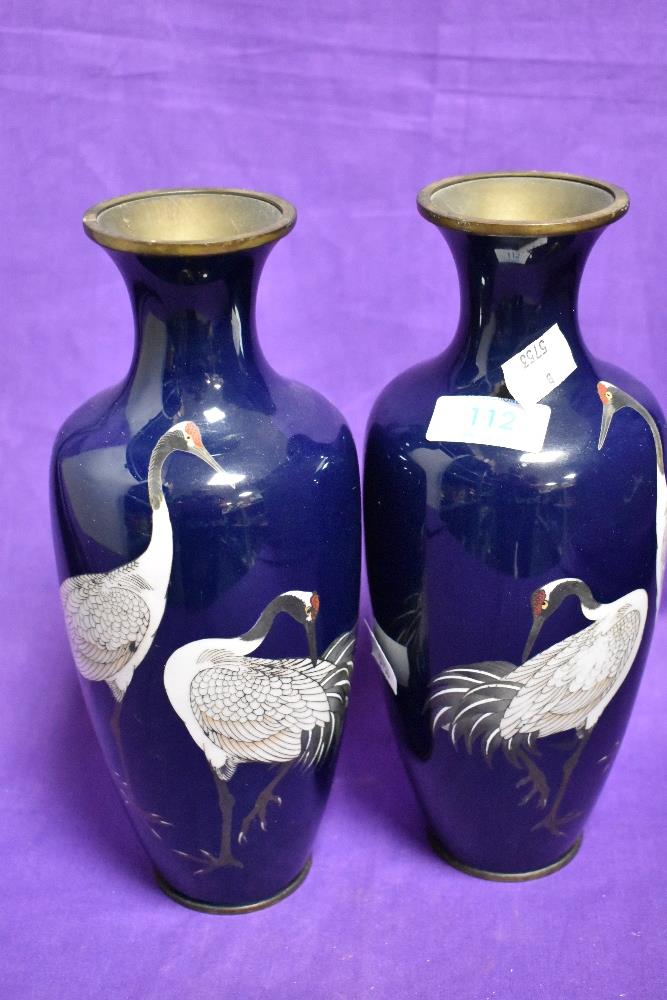 A pair of Japanese cloisonne enamel vasesm, having crane decoration.