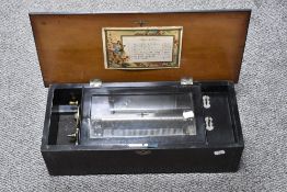 A 19th Century mahogany cased music box, having 8 airs, the pictorial card having hand written