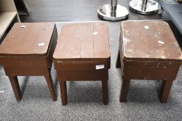 Three rustic wooden stools.