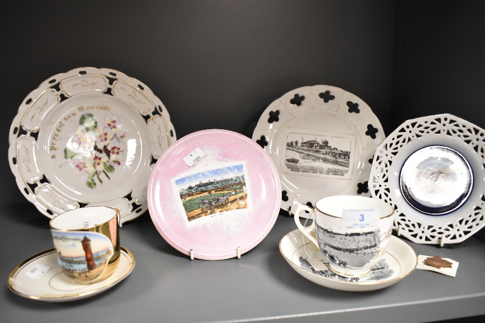 Two 19th Century porcelain souvenir teacups and saucers, both illustrated with scenes of