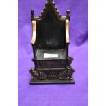 A cast metal penny bank modelled as Regal throne, EIIR, incised mark to reverse 'Harper'