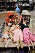 A variety of vintage dolls, including 1930s cloth faced doll, wooden and early plastic examples.