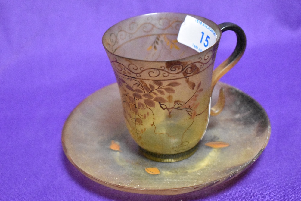 A 19th/20th Century gilt decorated and horn teacup and saucer, with flared rim, and measuring 7cm - Image 2 of 2