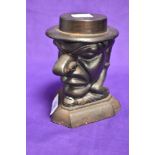 A 19th Century cast iron tobacco jar ,modelled as a dour faced man with lift lid hat.
