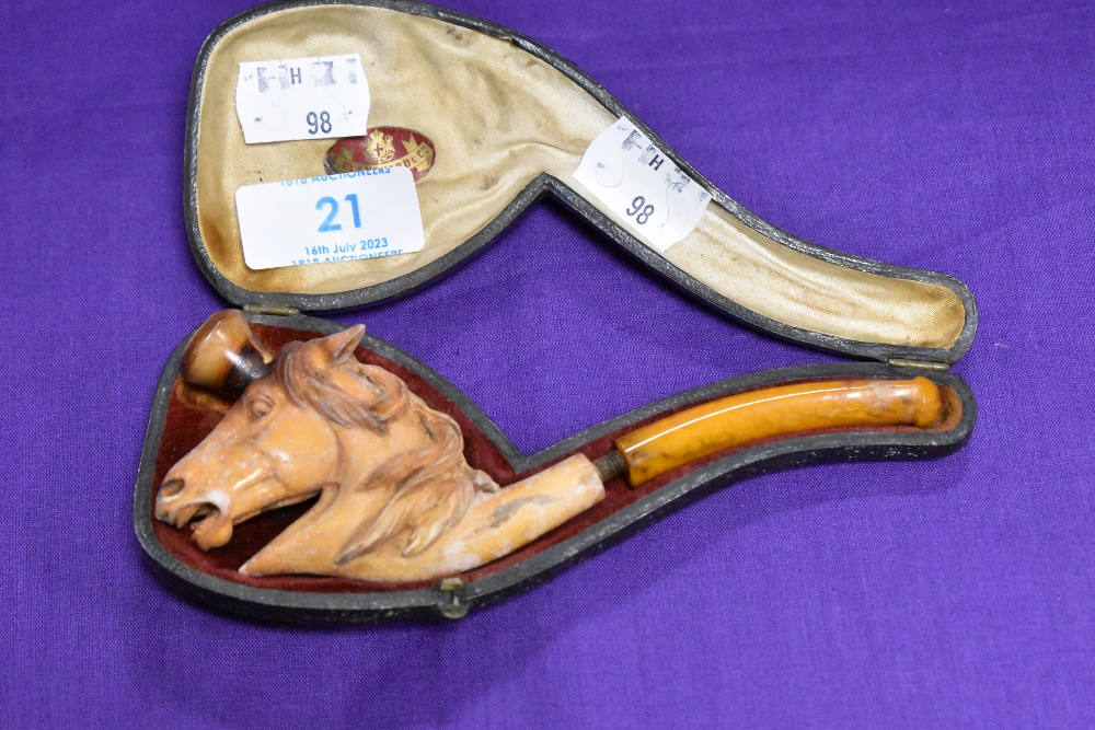 A 19th century meerschaum novelty smoking pipe in the form of a horse head and displayed in hard