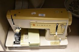 A 1960s Singer 449 sewing machine, with manual, pedal and case.