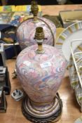 Two ginger jar formed lamp bases, having psychedelic feather like design in pink and blue hues.