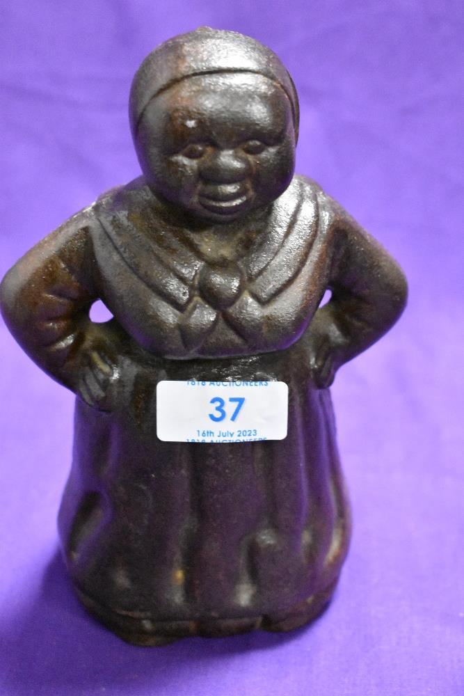 An early 20th century cast iron Aunt Jemima Mammy money bank, 18cm tall