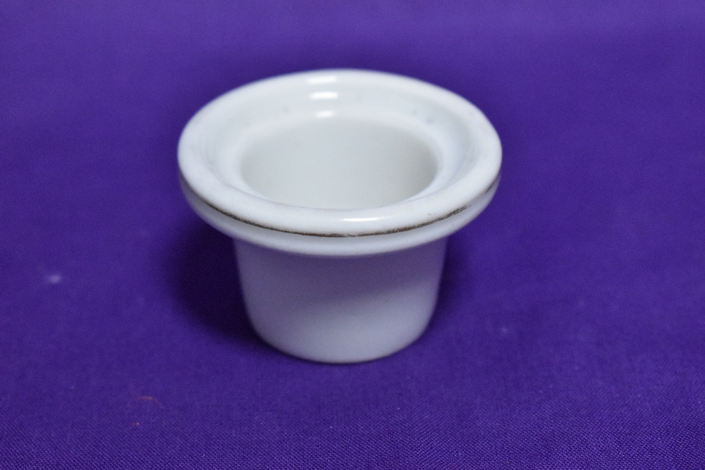 A glazed ceramic inkwell liner.