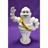 A cast metal advertising penny bank, Michelin man, height approx. 22cm