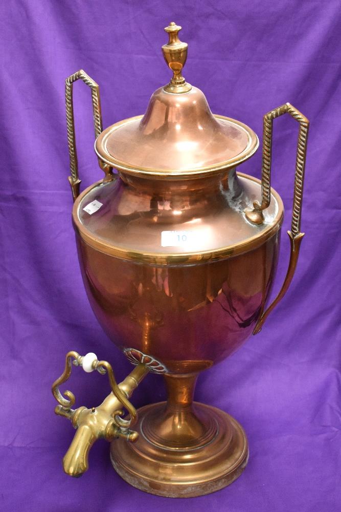 An antique copper and brass samovar, the body of classical vase form, and raised on a stepped