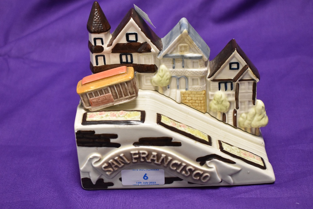 A Westland Co. ceramic musical ornament, in the form of a cable car within a San Francisco skyline