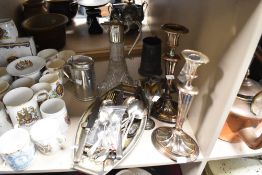 A Variued lot containing; two early 20th century Silver plated candlesticks, a hallmarked silver