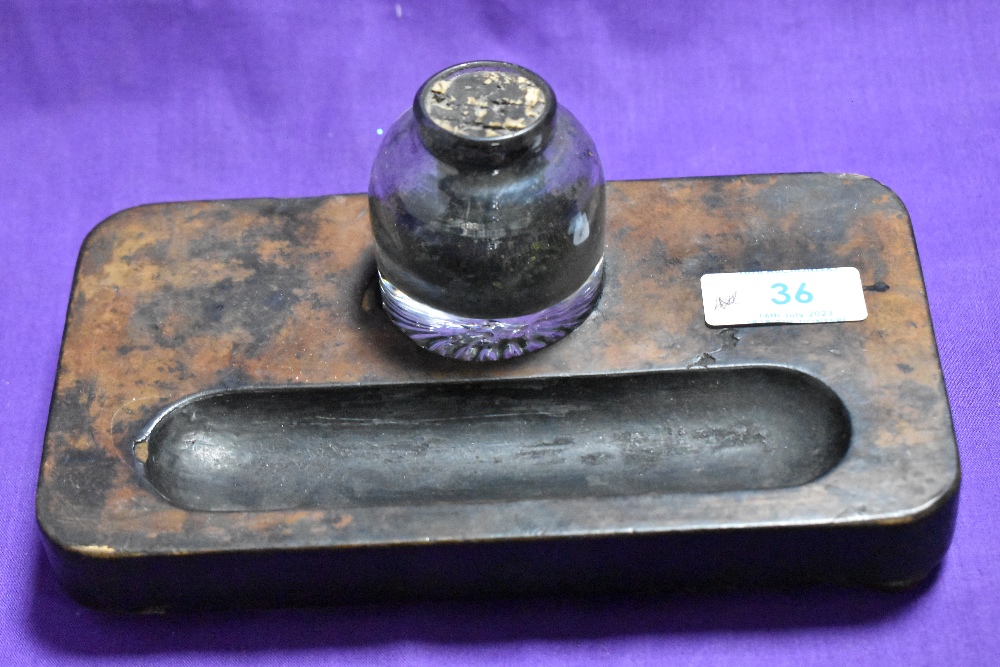 A walnut ink stand with glass ink bottle.