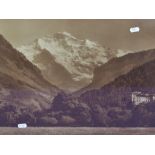 A sepia tone photographic print of an Alpine mountain view, displayed in a 20th Century oak frame,