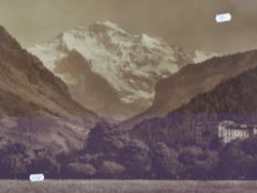 A sepia tone photographic print of an Alpine mountain view, displayed in a 20th Century oak frame,