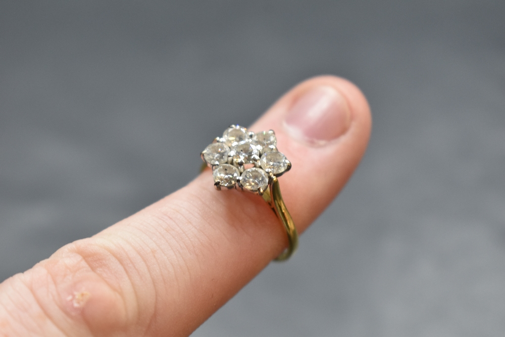 A seven stone diamond daisy cluster ring, total approx 1.5ct, in a raised claw set basket mount on - Image 2 of 2