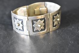 A Mexican silver six panel articulated bracelet having embossed decoration and concealed clasp,