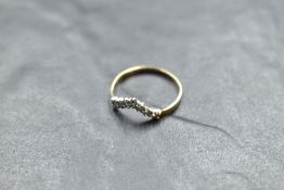 A seven stone diamond wishbone ring, total approx 0.25ct on a 9ct gold loop, size O & approx 1.1g