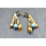 A pair of 18ct gold stud earrings having stylised paired drops with turquoise bead decoration and