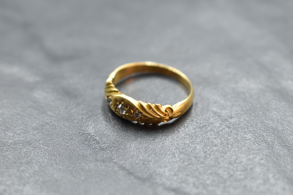 An Edwardian diamond chip set ring having a moulded mount on an 18ct gold loop, size L & approx 2.
