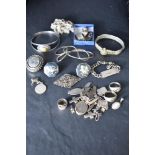 A selection of silver and white metal jewellery including cuff links, charms, locket, bracelets etc