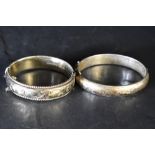 Two HM silver hinged bangles, both having engraved scroll decoration, approx 62g