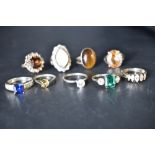 Nine white metal rings stamped silver including mother of Pearl, Tigers Eye, Cubic Zirconia etc