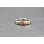 A diamond set platinum wedding band having five inset diamonds, total approx 0.2ct, size M &