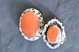A Victorian mourning brooch having carnelian panel to front and yellow metal reverse bearing