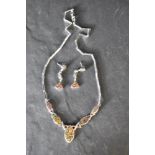 A silver and faux black opal articulated necklace having five opal panels with fixed oblong link