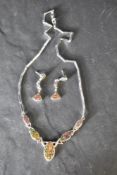 A silver and faux black opal articulated necklace having five opal panels with fixed oblong link