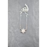 A silver necklace by Fei Lui having a cubic zirconia set multi point star on a fixed chain