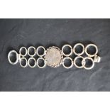 A 1970's HM silver bracelet of stylised form having concealed clasp and bearing makers mark PW,