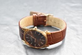 A gent's quartz wrist watch by Skagen, model: 859LRLD, having baton numeral dial on decorative brown