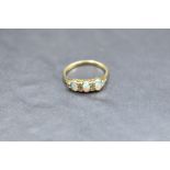 An opal and diamond ring having a trio of opal cabochons with diamond chip spacers in a gallery