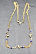 An Italian 14k yellow metal and lapis lazuli dolphin design double chain necklace, marked 585 *510