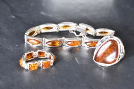 Three pieces of Baltic Amber and silver jewellery including large ring, articulated panelled