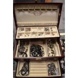 A modern concertina jewellery case containing a variety of white metal and costume jewellery