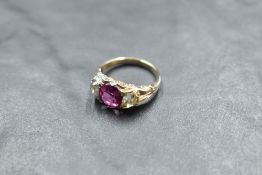A Victorian ruby and diamond ring, the central ruby approx 1.25ct flanked by two old cut diamonds,