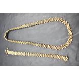 A 9ct gold brick link collerette necklace and matching bracelet, both having concealed clasps,