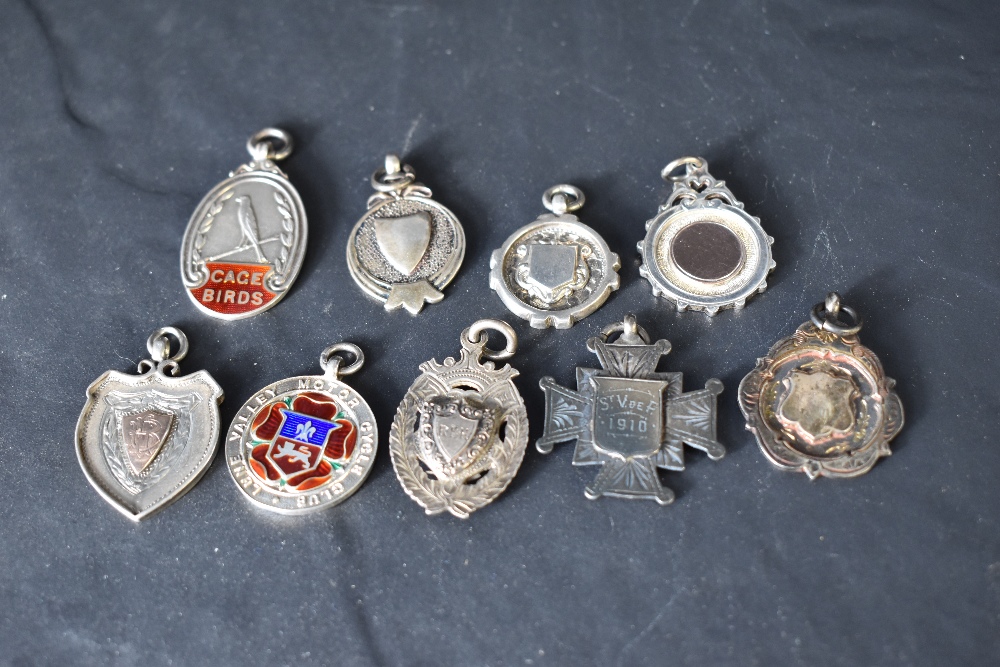 Nine silver medallions of various forms including Lune Valley Motor Cycle Club, Cage Birds etc,