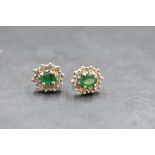 A pair of 9ct gold stud earrings having emerald style and diamond chip clusters, approx 3g gross